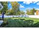 Manicured backyard featuring a lush green lawn, privacy fence, and mature trees at 51 Wilson Dr, Carmel, IN 46032
