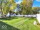 Large backyard with a lush lawn, shed, and mature trees providing shade at 51 Wilson Dr, Carmel, IN 46032