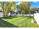 Beautifully maintained backyard with a large lawn, white fence, and charming shed at 51 Wilson Dr, Carmel, IN 46032