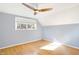 Bright bedroom with ceiling fan, hardwood floors, and natural light from window at 51 Wilson Dr, Carmel, IN 46032