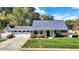 Attractive single-story home showcasing a manicured lawn, brick accents, and an attached two-car garage at 51 Wilson Dr, Carmel, IN 46032