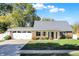 Charming single-story brick home with well-maintained landscaping and an attached two-car garage at 51 Wilson Dr, Carmel, IN 46032