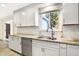 Bright kitchen with stainless steel appliances, white cabinets, and stone countertops at 51 Wilson Dr, Carmel, IN 46032