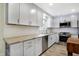 Well-lit kitchen featuring light gray cabinets, stainless steel appliances, and updated countertops at 51 Wilson Dr, Carmel, IN 46032