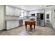 Bright, open kitchen featuring stainless steel appliances, light gray cabinets, and updated countertops at 51 Wilson Dr, Carmel, IN 46032