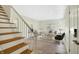 Bright, neutrally decorated living room with a staircase, hardwood floors, and comfortable seating at 51 Wilson Dr, Carmel, IN 46032