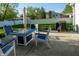 Outdoor patio area featuring a fire pit table, chairs, and a grill, perfect for entertaining at 51 Wilson Dr, Carmel, IN 46032