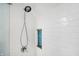 Shower with white subway tile and built-in niche featuring glass blue tile at 51 Wilson Dr, Carmel, IN 46032