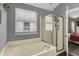 Bathroom features a jacuzzi tub and a glass enclosed shower at 5348 Pelham Way, Indianapolis, IN 46216