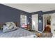 Comfortable bedroom with a window providing natural light, wooden floors, and a built-in study space at 5348 Pelham Way, Indianapolis, IN 46216