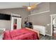 Bedroom features a ceiling fan and views of the ensuite bathroom at 5348 Pelham Way, Indianapolis, IN 46216