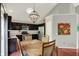 Bright dining area with dark cabinets, stainless steel appliances, and wood-finished dining table at 5348 Pelham Way, Indianapolis, IN 46216