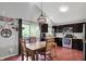 The dining area features a rustic table, dark cabinetry and a sliding door that leads to the deck at 5348 Pelham Way, Indianapolis, IN 46216