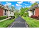 Paved driveway leading to homes with well-maintained lawns and mature trees at 5348 Pelham Way, Indianapolis, IN 46216
