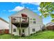 A charming home exterior features a spacious wooden deck, perfect for outdoor relaxation at 5348 Pelham Way, Indianapolis, IN 46216