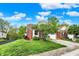 A well-manicured lawn and charming brick home with a two-car garage on a sunny day at 5348 Pelham Way, Indianapolis, IN 46216