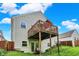 Home exterior boasts a sizable deck for relaxation plus a serene yard, blending comfort with nature at 5348 Pelham Way, Indianapolis, IN 46216