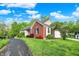Attractive brick home with lush landscaping, a driveway, and a two-car garage at 5348 Pelham Way, Indianapolis, IN 46216