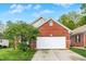 Charming brick home with a well-maintained lawn and attached two-car garage at 5348 Pelham Way, Indianapolis, IN 46216