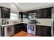 Modern kitchen with stainless steel appliances, dark cabinetry, and lots of counter space at 5348 Pelham Way, Indianapolis, IN 46216
