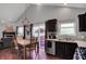 Kitchen and dining area showcasing dark cabinets, stainless appliances, and access to outdoor deck at 5348 Pelham Way, Indianapolis, IN 46216