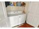 Efficient laundry area featuring a washer and dryer setup, plus shelf storage above at 5348 Pelham Way, Indianapolis, IN 46216