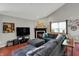 Cozy living room features a large sectional sofa, fireplace, and a large-screen television at 5348 Pelham Way, Indianapolis, IN 46216
