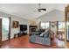 Open-concept living room featuring hardwood floors, fireplace, and a vaulted ceiling at 5348 Pelham Way, Indianapolis, IN 46216