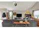 Open living room featuring vaulted ceilings, a fireplace, and ample seating with a large sectional sofa at 5348 Pelham Way, Indianapolis, IN 46216