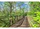 Scenic wooden walkway with lush greenery on either side, perfect for a peaceful stroll at 5348 Pelham Way, Indianapolis, IN 46216