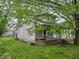 Home exterior with fresh gray paint, a small front porch, and mature trees at 550 W King St, Franklin, IN 46131