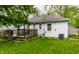 Exterior view of the house showing the deck, air conditioner, and backyard with lush green grass at 5643 Rosslyn Ave, Indianapolis, IN 46220