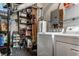 Basement laundry area with washer, dryer, shelving, and hot water tank, providing ample storage space at 5643 Rosslyn Ave, Indianapolis, IN 46220
