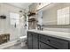 Modern bathroom with a glass-enclosed shower, a vanity, and industrial shelving at 5643 Rosslyn Ave, Indianapolis, IN 46220