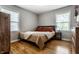 Bedroom with hardwood floors, large windows and neutral paint at 5643 Rosslyn Ave, Indianapolis, IN 46220