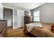 Cozy bedroom with hardwood floors, window, and two closets at 5643 Rosslyn Ave, Indianapolis, IN 46220