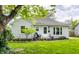 Charming single-story house featuring a well-kept lawn, fresh landscaping, and covered front porch at 5643 Rosslyn Ave, Indianapolis, IN 46220