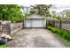 Detached garage with a wide driveway and partial view of the yard, providing ample parking and storage at 5643 Rosslyn Ave, Indianapolis, IN 46220