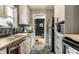 Well-lit kitchen features shaker cabinets, wood countertop, hexagon tile floor and stainless steel appliances at 5643 Rosslyn Ave, Indianapolis, IN 46220