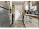 Galley kitchen with white cabinets, wood countertops, stainless steel appliances and hexagon tile floor at 5643 Rosslyn Ave, Indianapolis, IN 46220