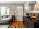 Well-lit living room featuring a comfortable sofa, hardwood floors, and a chic console at 5643 Rosslyn Ave, Indianapolis, IN 46220