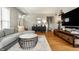 Comfortable living area with stylish furniture, a media center, and hardwood flooring at 5643 Rosslyn Ave, Indianapolis, IN 46220