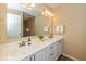 Bathroom featuring a double vanity sink, white cabinets, and a large mirror at 5744 Spruce Knoll Ct, Indianapolis, IN 46220