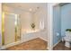 Bathroom featuring a tub with a glass shower door, toilet, and neutral finishes at 5744 Spruce Knoll Ct, Indianapolis, IN 46220