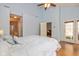 Bright bedroom featuring hardwood floors, access to a bathroom, and a seating area at 5744 Spruce Knoll Ct, Indianapolis, IN 46220