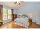 Light-filled bedroom with wood floors, blue walls, and a large window at 5744 Spruce Knoll Ct, Indianapolis, IN 46220