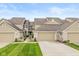 Charming townhome with an attached two-car garage, well-maintained lawn, and welcoming front entrance at 5744 Spruce Knoll Ct, Indianapolis, IN 46220