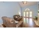 Comfortable living room featuring hardwood floors, high ceilings, and a large window with French doors at 5744 Spruce Knoll Ct, Indianapolis, IN 46220