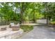 Private backyard with wood deck, seating, and driveway leading to a detached two-car garage at 5829 Broadway St, Indianapolis, IN 46220