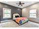 Spacious bedroom with a comfortable bed and a large window at 5829 Broadway St, Indianapolis, IN 46220